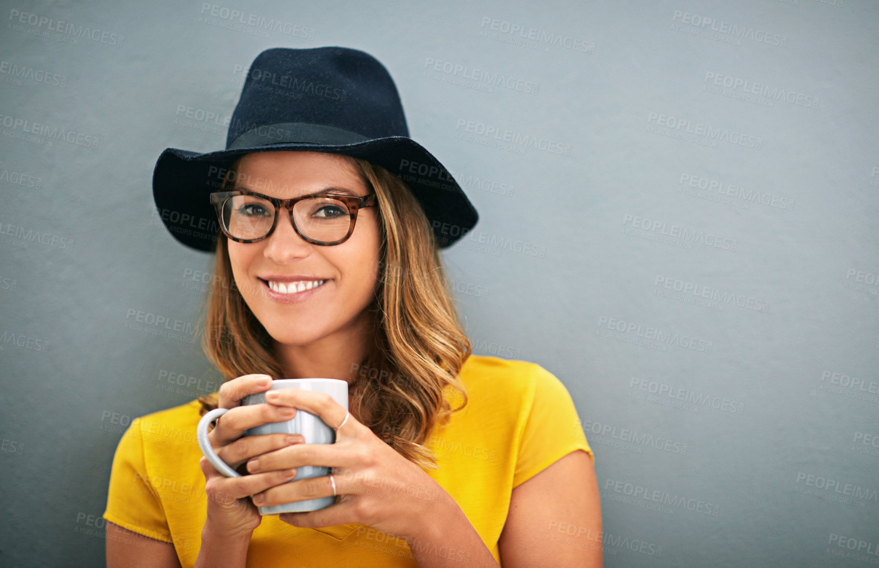 Buy stock photo Face, woman and coffee with glasses for vision, caffeine and good mood in studio with smile on grey background. Mockup space, eyewear and warm beverage with portrait, relax for positivity and drink
