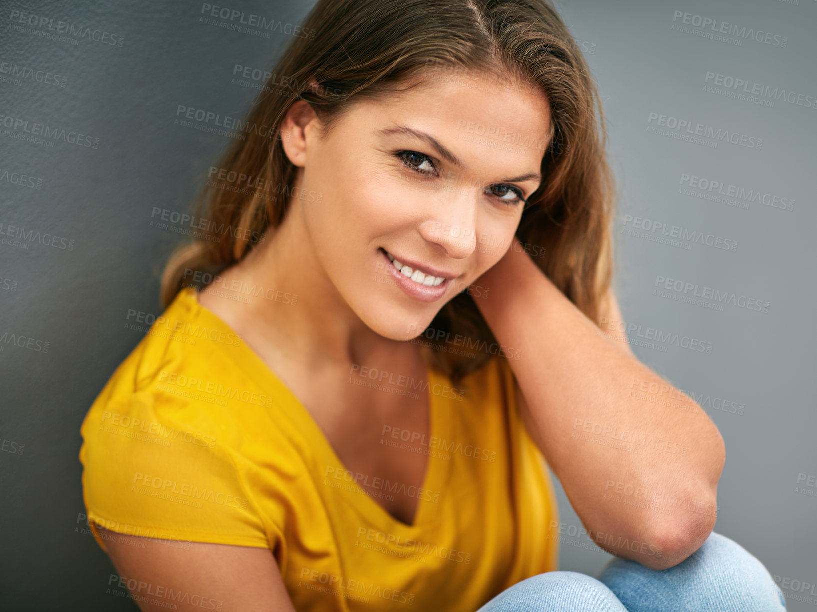 Buy stock photo Wall, smile and woman on floor, portrait and relax for weekend, Gen z and streetwear for fashion in house. Grey background, happiness and girl in apartment, cheerful and comfortable on ground of home