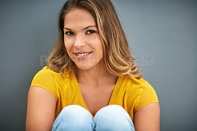 Buy stock photo Woman, portrait and sitting on ground by studio background with smile, yellow and mockup for marketing. Happy, confidence and face of gen z model by dark backdrop with color and space for advertising