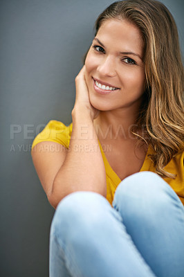 Buy stock photo Wall, peace and woman on floor, portrait and relax for weekend, Gen z and smile for fashion in house. Grey background, happiness and girl in apartment, cheerful and comfortable on ground of home