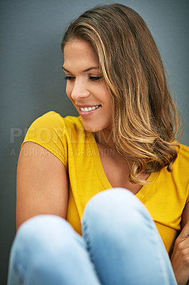 Buy stock photo Wall, weekend and woman on floor, rest and relax for with smile, Gen z and streetwear for fashion in house. Grey background, happiness and girl in apartment, cheerful and comfortable on ground