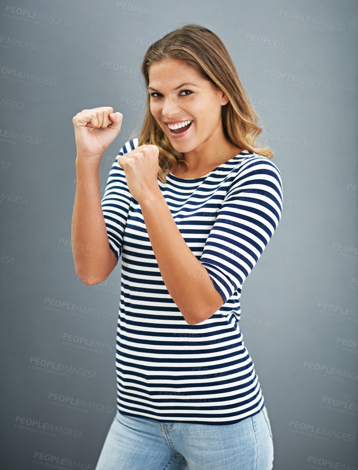 Buy stock photo Portrait of a young woman holding up her fists playfully