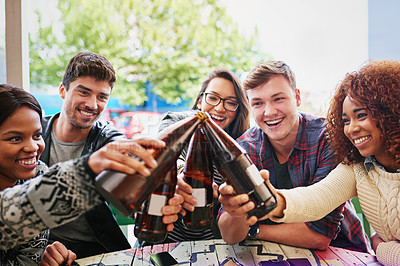 Buy stock photo Cropped shot of a group of friends hanging out and drinking beers