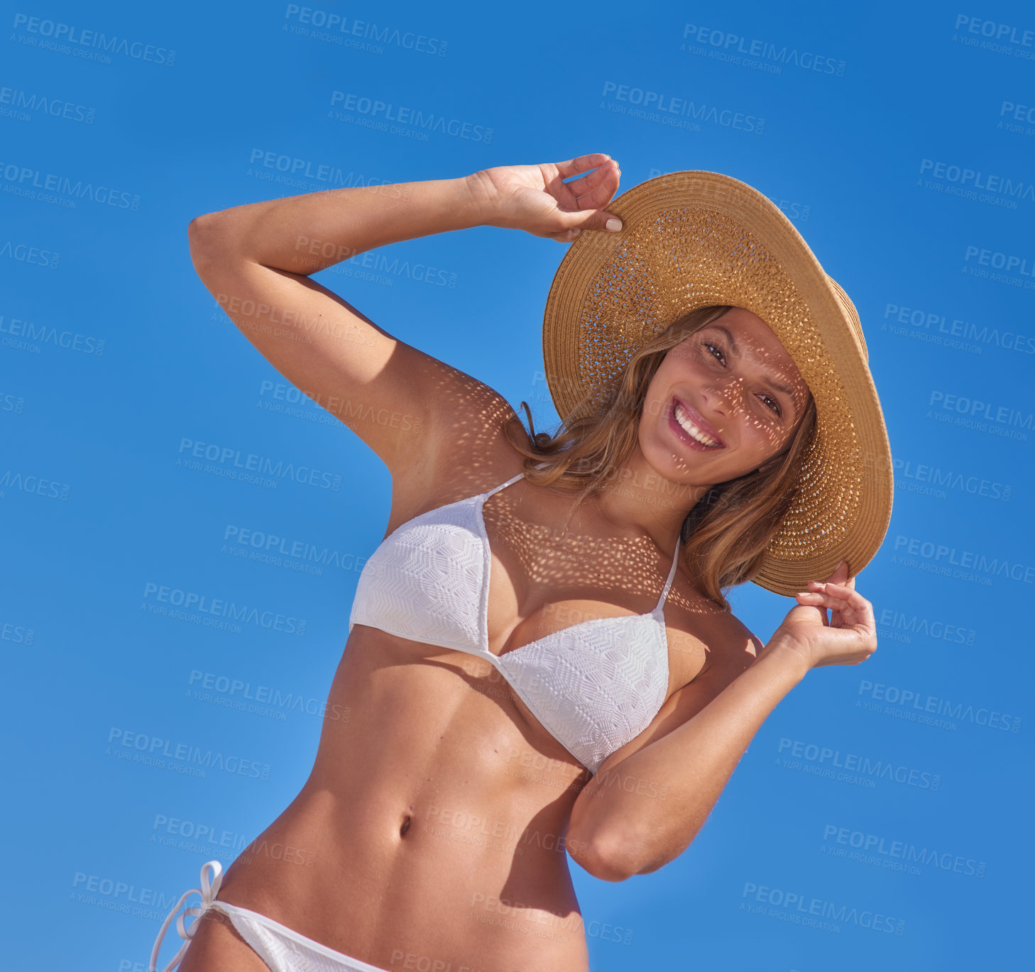 Buy stock photo Woman, bikini and sky at beach with smile on portrait in summer or hot weather on holiday, break and rest in Bali. Low angle, female person and happy with hat in swimwear on trip, vacation and relax