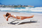 Young woman lying on sand at beach