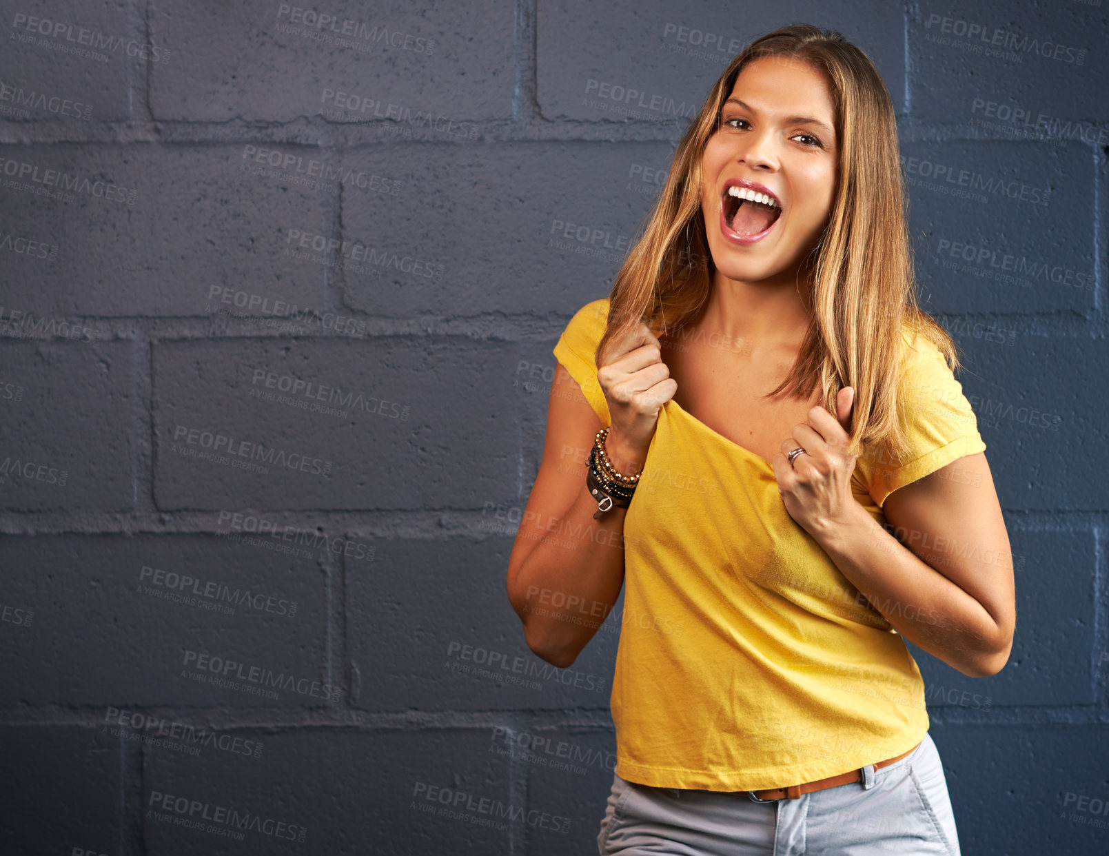 Buy stock photo Happy woman, portrait and fashion with expression for prize or joy on a gray brick wall background. Face of young female person with smile or friendly attitude for casual clothing or style on mockup