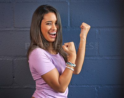 Buy stock photo Cropped portrait of a young woman putting up her fists against a brick wall background
