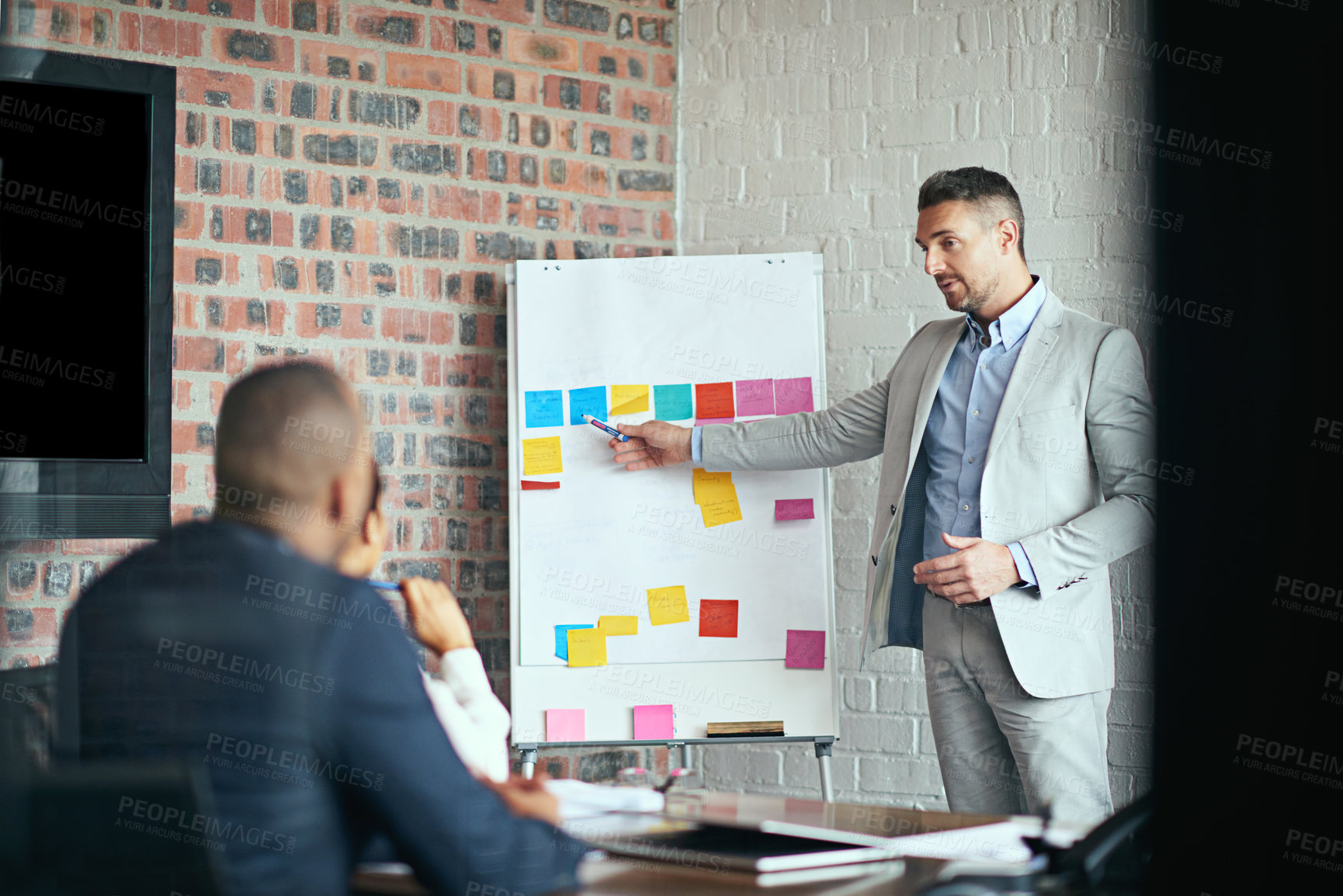 Buy stock photo Cropped shot of a businessman giving a presentation in the boardroom