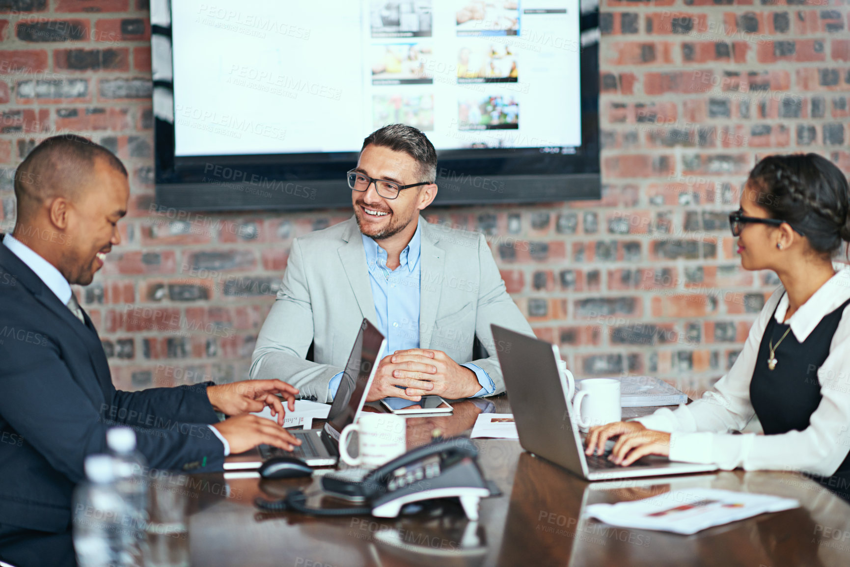 Buy stock photo Cropped shot of a group of businesspeople meeting in the boardroom