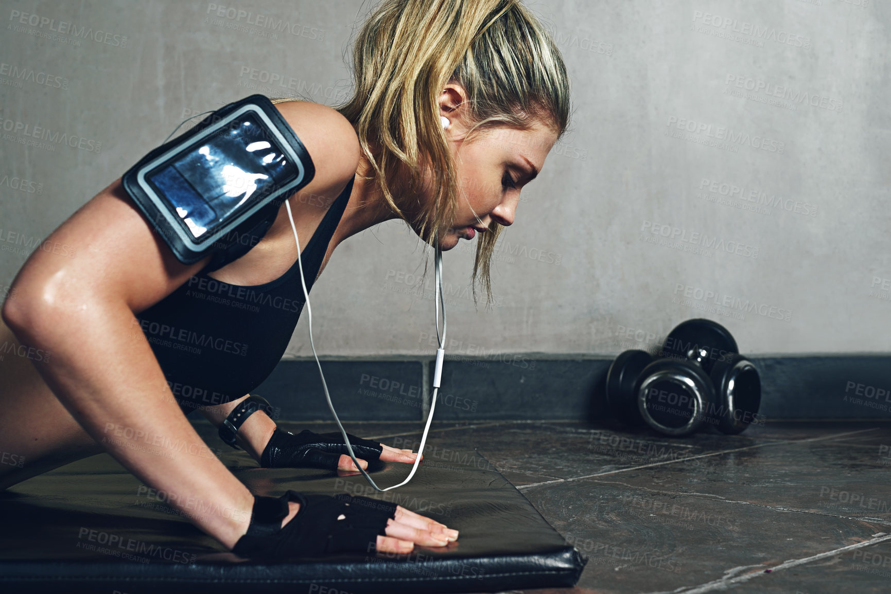 Buy stock photo Shot of a young woman doing push ups