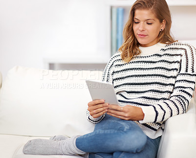 Buy stock photo Woman, tablet and reading on couch in house to relax for ebook, story and subscription to newsletter on web. Girl, person and digital touchscreen for app, social media and streaming on lounge sofa