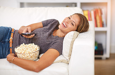 Buy stock photo Woman, sofa and popcorn with remote and laugh in home, snack and watching on weekend. Comedy, entertainment and food for movie or show, streaming or living room on couch for relax and self care