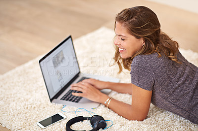 Buy stock photo Laptop, woman and college student in home typing online for remote or distance learning on technology. Smile, assessment task or girl on floor in house for university project, studying or development