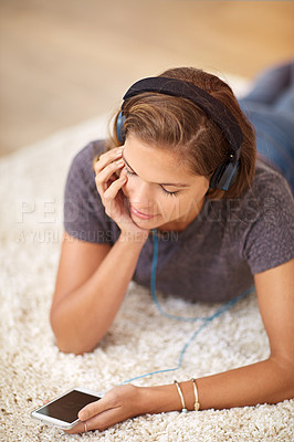 Buy stock photo Carpet, headphones or woman with phone for music streaming, subscription or wellness in home. Smile, girl or female person listening to audio, track or song to relax on floor on mobile app for peace