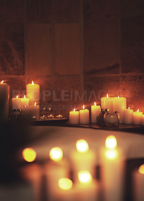 Buy stock photo Candles, luxury and spa for ambient and flame, relax and massage room for salon treatment. Aromatherapy, fire and burning for scent for holistic care, wellness and calm with light for zen in service