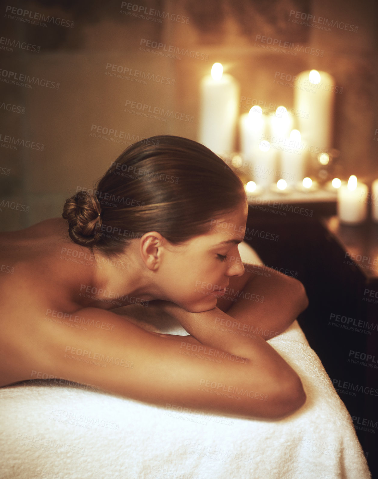 Buy stock photo Peace, woman and zen on massage bed for glow, wellness and cosmetics with candles in spa. Relax, beauty and female person sleeping after aromatherapy, luxury and stress relief at hotel for holiday