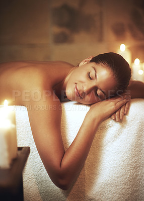 Buy stock photo Woman, zen and relax on massage bed for glow, wellness and cosmetics with candles. Beauty salon, client and sleeping with peace after spa, deep tissue and stress relief on vacation at hotel.