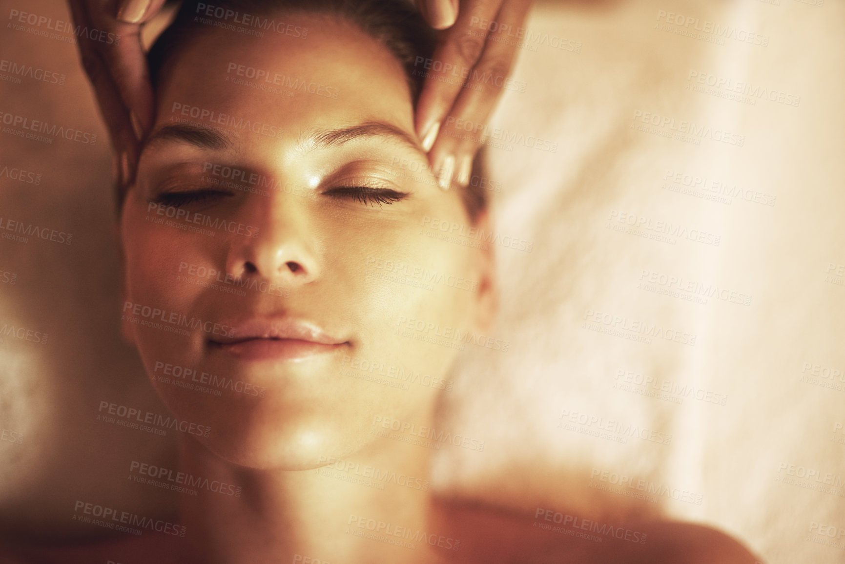 Buy stock photo Closeup shot of a young woman enjoying a head massage at the spa