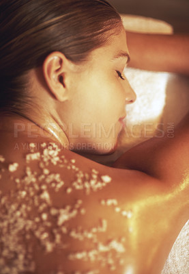 Buy stock photo Cropped shot of a young woman getting an exfoliating treatment at the spa