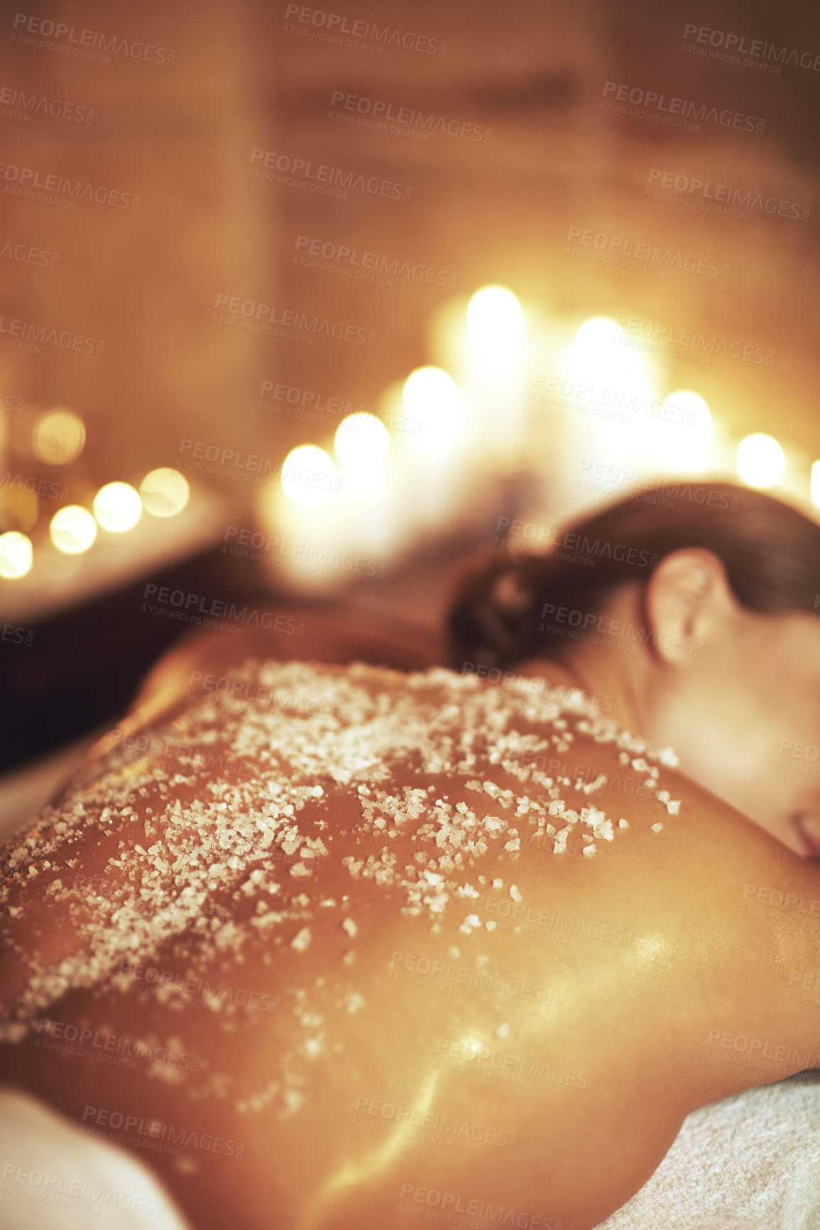 Buy stock photo Cropped shot of a young woman getting an exfoliating treatment at the spa