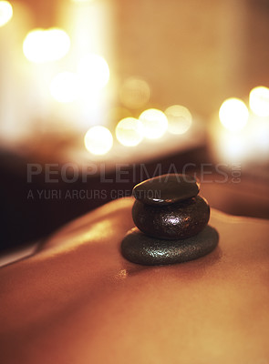 Buy stock photo Person, back and hot stone treatment or spa relax at hotel resort or luxury holiday, stress relief or muscle. Client, wellness and tension release or candle bokeh for skincare health, massage or calm