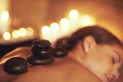 Buy stock photo Woman, hot stone and spa relax or treatment or skin care at hotel resort or muscle tension, recovery or peace. Female person, sleep and stress relief luxury for Bali holiday or calm, health or bokeh