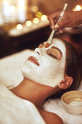 Buy stock photo Shot of a young woman enjoying a facial treatment at the spa