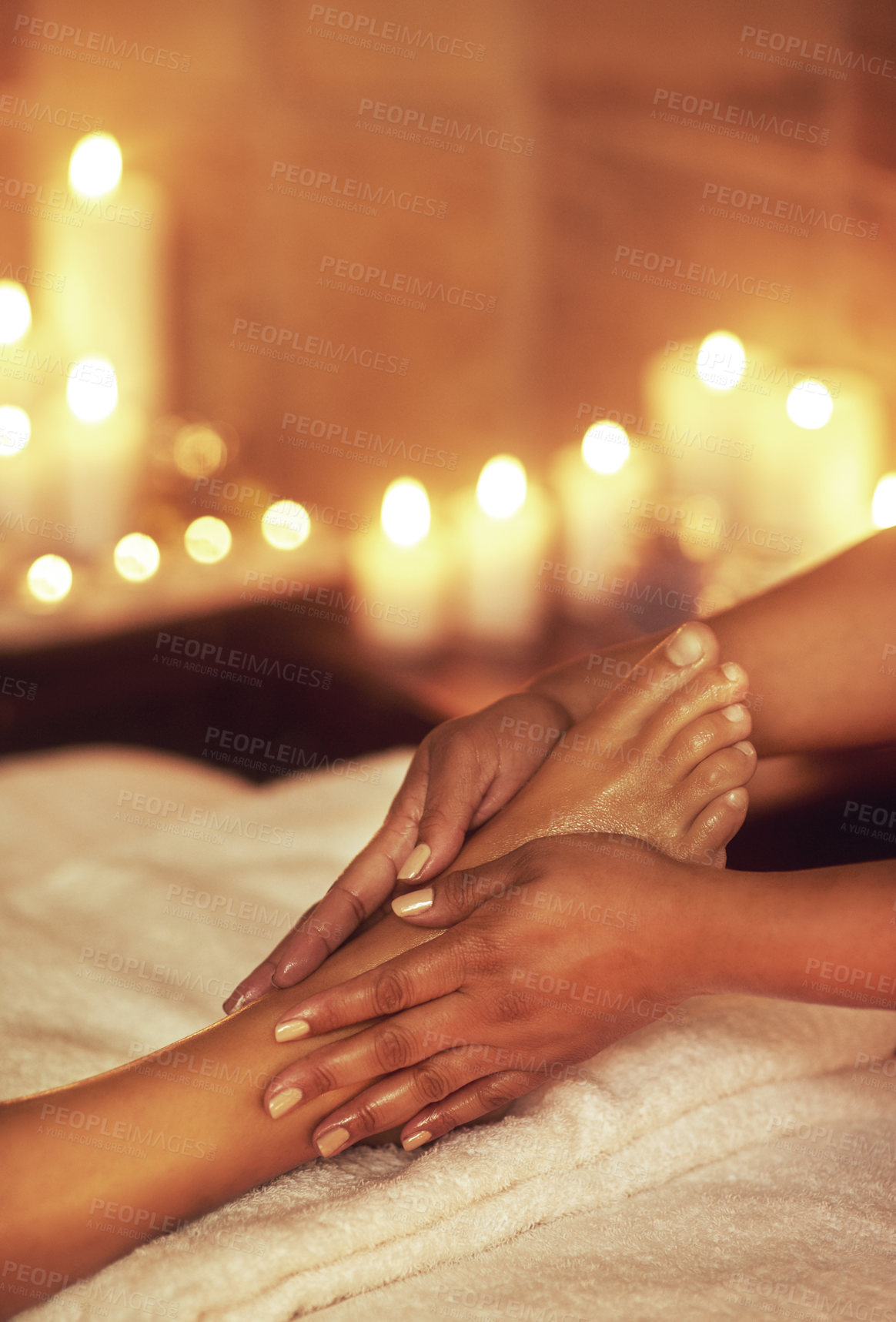 Buy stock photo Person, foot and hands for spa massage or relax client in hotel resort with candles, bokeh or recovery. Masseuse, stress relief and muscle tension or reflexology with pressure points, calm or rest