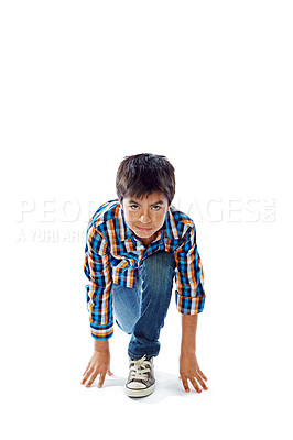 Buy stock photo Studio portrait of a young boy in a starting position against a white background