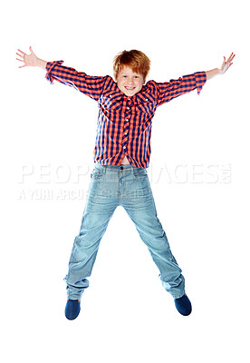 Buy stock photo Studio shot of a young boy jumping for joy against a white background