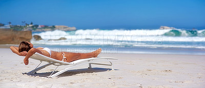 Buy stock photo Woman, relax and chair for sunbathing at beach with tropical vacation, summer peace and calm morning. Tanning, female person and rest for ocean break, blue sky and bikini of holiday island outdoor