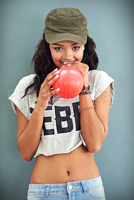 Buy stock photo Blowing, balloon and portrait of girl with fashion, streetwear and celebrate a sale at boutique. Excited, woman and gen z model with cool style, clothes or happiness for party on studio background