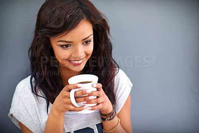 Buy stock photo Happy girl, drinking and coffee with mug for morning, caffeine or beverage on a gray studio background. Female person, brunette or model with smile for latte, cappuccino or espresso on mockup space