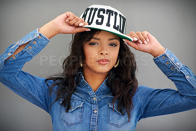 Buy stock photo Portrait, fashion and confident woman with cap in studio for style, cool or trendy isolated on gray background. Face, hat and serious young model in clothes, streetwear or denim on backdrop in Brazil