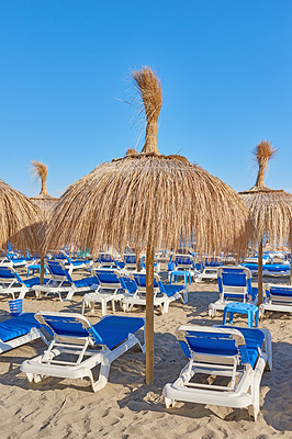 Buy stock photo Beach chair, summer and umbrella with vacation, resort and luxury hotel with sand and lounge area. Sea, ocean and villa with sun, tourism and weekend break for Spain getaway and tropical trip 