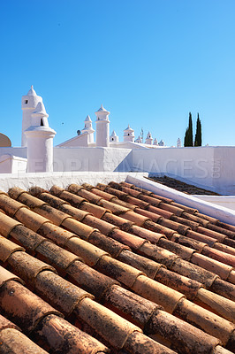 Buy stock photo Building, rooftop and tiles with chimney, architecture and blue sky for ventilation with aesthetic. Culture, heritage and terracotta with sustainability, insulation or eco friendly clay roof in Spain