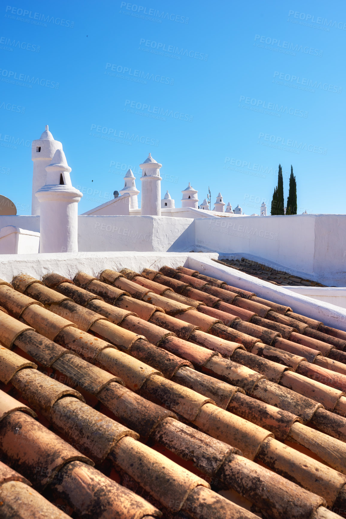 Buy stock photo Building, rooftop and tiles with chimney, architecture and blue sky for ventilation with aesthetic. Culture, heritage and terracotta with sustainability, insulation or eco friendly clay roof in Spain