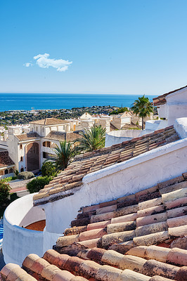 Buy stock photo Building, rooftop and tiles with landscape, architecture and blue sky for travel with aesthetic. Culture, heritage and terracotta with sustainability, insulation or eco friendly clay roof in Spain