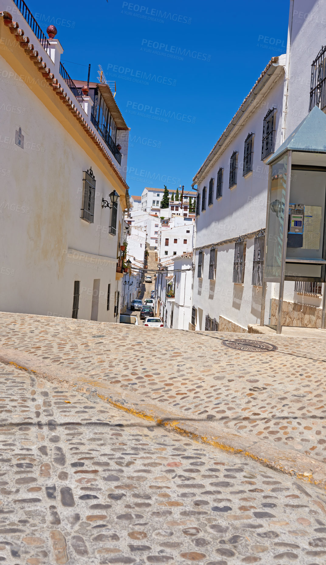 Buy stock photo Buildings, road and low angle with architecture, travel or blue sky for holiday location with aesthetic. Culture, heritage and outdoor in street with tourism, sightseeing or vacation as town in Spain