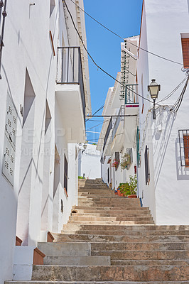 Buy stock photo Buildings, town and steps outdoor with architecture, travel and exploration with blue sky or aesthetic. Infrastructure, village and stairs outside for holiday, climbing and tourist location in Spain