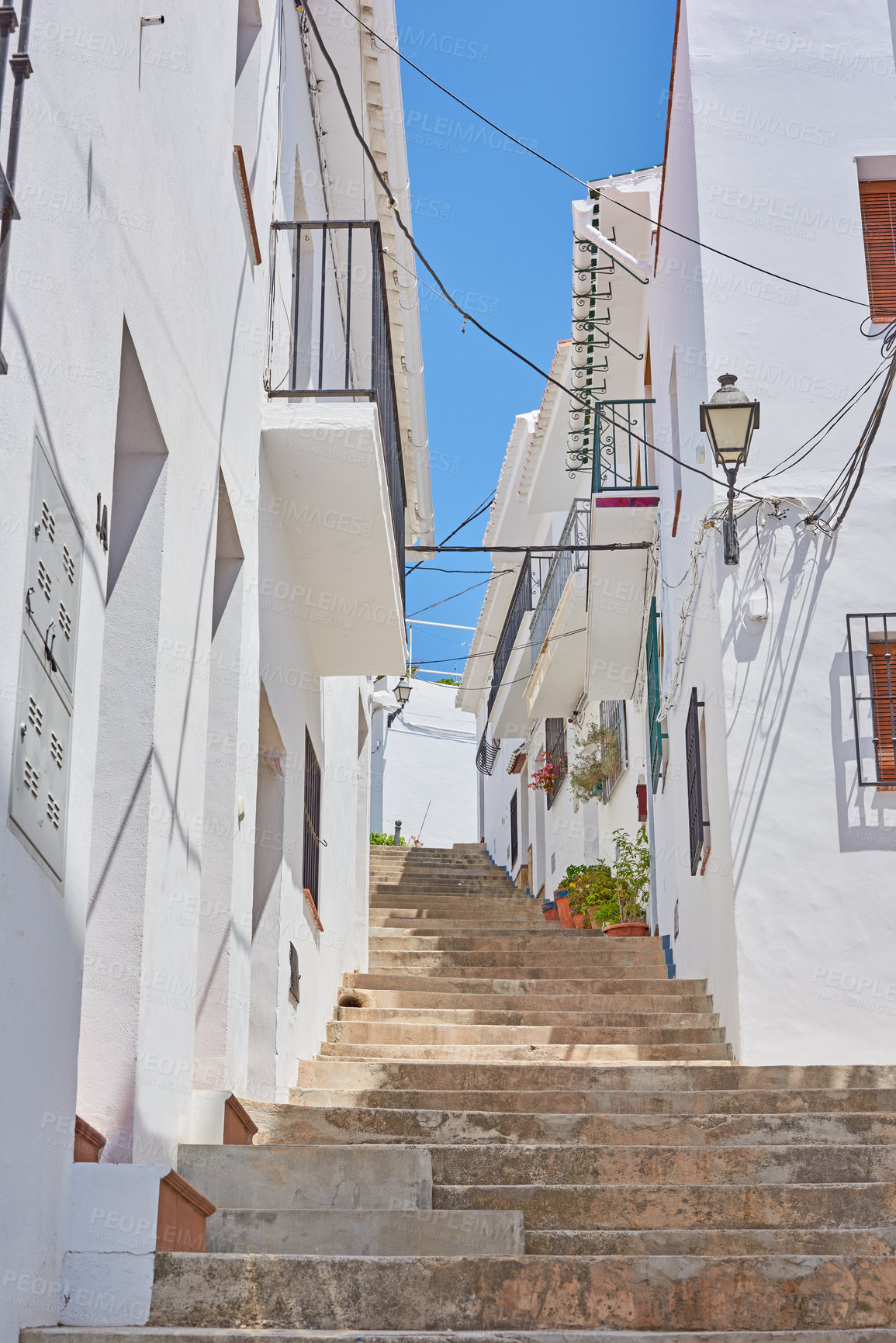 Buy stock photo Buildings, town and steps outdoor with architecture, travel and exploration with blue sky or aesthetic. Infrastructure, village and stairs outside for holiday, climbing and tourist location in Spain