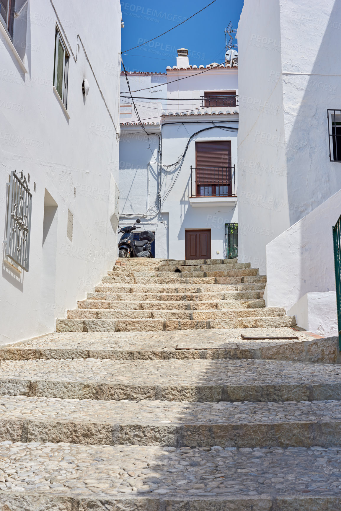 Buy stock photo Buildings, town and steps with architecture, travel and exploration with blue sky or aesthetic outdoor. Infrastructure, village and stairs outside for holiday, climbing and tourist location in Spain