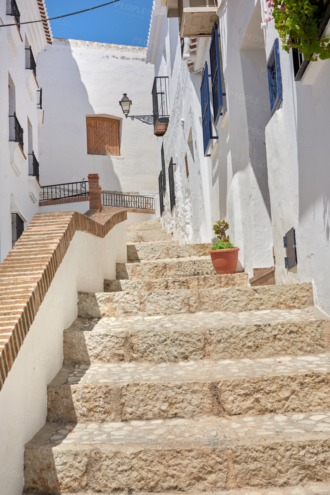 Buy stock photo Buildings, town and steps outside with architecture, travel and exploration with blue sky or aesthetic. Infrastructure, village and stairs outdoor for holiday, climbing and tourist location in Spain