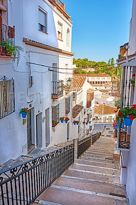 Buy stock photo Buildings, town and stairs outside with architecture, travel and exploration with blue sky or aesthetic. Infrastructure, village and steps outdoor for holiday, climbing and tourist location in Spain