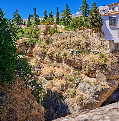 Buy stock photo Mountain, buildings and house on cliff in Spain with antique structures, culture and property. Outdoor, architecture and landscape of town for adventure, travel destination and tourism in nature