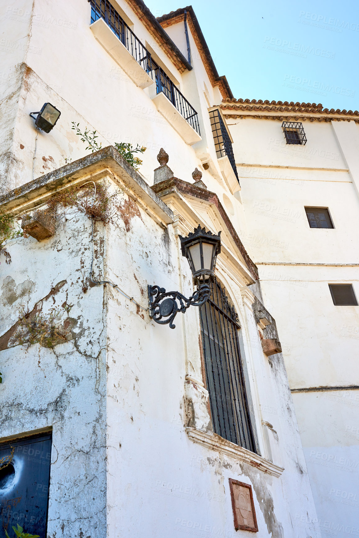 Buy stock photo Heritage, whitewash and broken house for architecture, buildings or travel in Spain. Ronda, old city and village design with history for exploration, culture and cracked stone in Europe for aesthetic