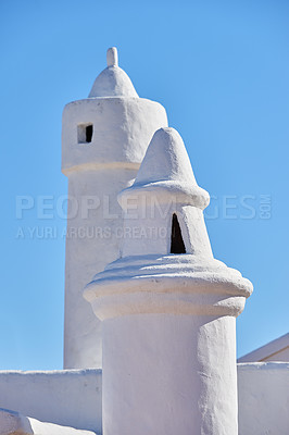 Buy stock photo Andalusian architecture, chimney and roof on house outdoor for travel, vacation and tourism at village in Spain. Traditional, ventilation tower and building for history, design and blue sky at home