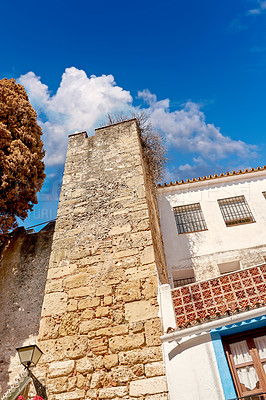 Buy stock photo Ancient, building and architecture house with blue sky for city travel, history tourism and vintage location. Urban, above and wall structure for traditional culture, holiday and destination in Spain