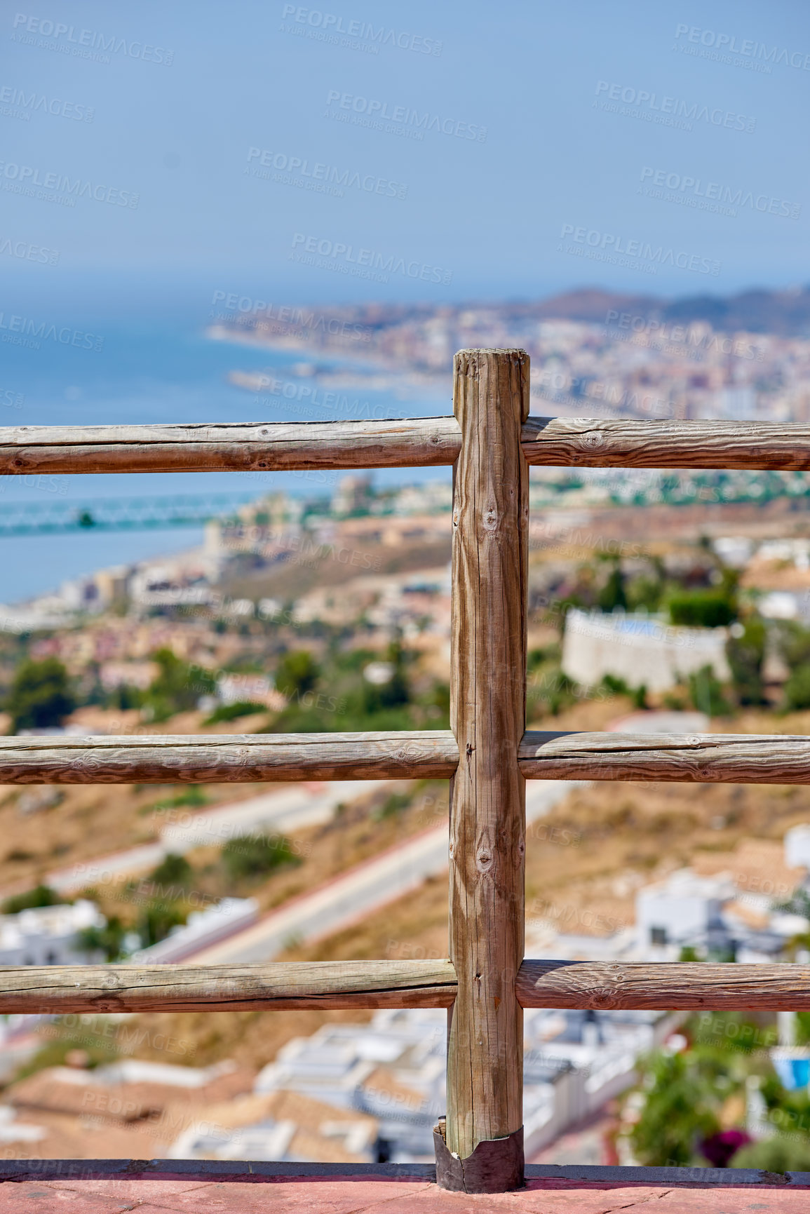 Buy stock photo Railing, city view and outdoor travel for sightseeing, tourism and urban Malaga for peace or calm. Trip, Spain vacation and town scenery in environment, wooden fence and holiday break in Europe