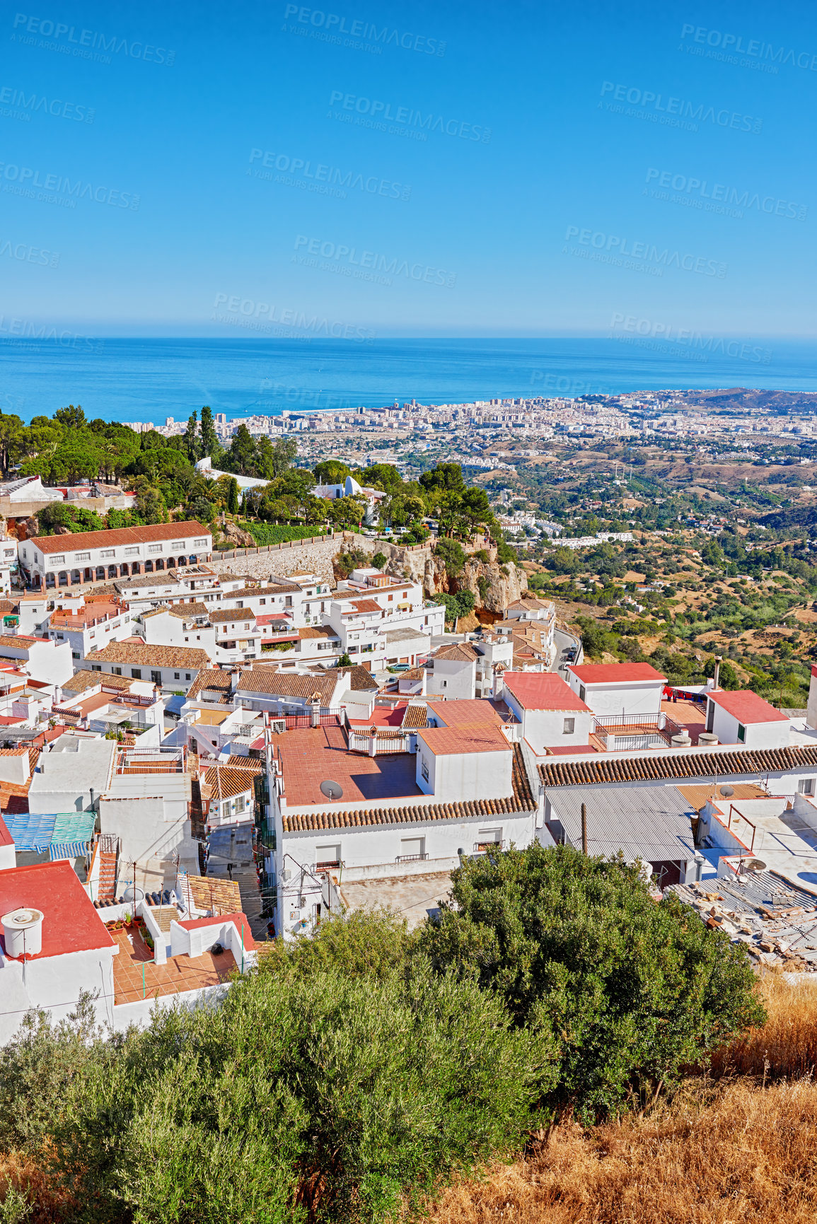 Buy stock photo Nature, buildings and city for travel, destination or holiday in Andalusia with vintage architecture. Location, blue sky and top view of houses outdoor in village for vacation or getaway in Spain.